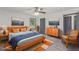 Bright bedroom featuring a ceiling fan, stylish decor, artwork and a comfortable bed at 5406 Jamestowne Dr, Powder Springs, GA 30127