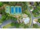 Aerial view showcasing the community pool, tennis and basketball courts, playground, and surrounding residences at 8032 Ridge Vly, Woodstock, GA 30189