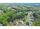 Sprawling aerial view of neighborhood homes surrounded by lush green trees and winding roads at 8032 Ridge Vly, Woodstock, GA 30189