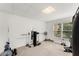 Finished basement includes a home gym area with equipment and a window, with carpet floors at 8032 Ridge Vly, Woodstock, GA 30189