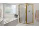 Bright bathroom featuring a glass door shower, soaking tub, and a garden window at 8032 Ridge Vly, Woodstock, GA 30189