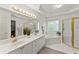 Luxurious bathroom featuring a double vanity, large mirror, and separate tub and shower at 8032 Ridge Vly, Woodstock, GA 30189