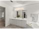 Well-lit bathroom with dual sinks, a soaking tub, and updated fixtures and features at 8032 Ridge Vly, Woodstock, GA 30189