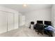 This bedroom features carpet floors, two windows and a closet, and a workspace at 8032 Ridge Vly, Woodstock, GA 30189