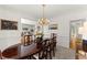 Formal dining room featuring an elegant chandelier and seating for six at 8032 Ridge Vly, Woodstock, GA 30189