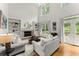 Spacious living room with a fireplace, built-in bookshelves, and hardwood floors at 8032 Ridge Vly, Woodstock, GA 30189