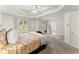 Spacious main bedroom featuring tray ceilings, large windows, and neutral decor at 8032 Ridge Vly, Woodstock, GA 30189