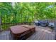 Back deck featuring a hot tub, grill, and table for outdoor dining at 1059 Verbena Way, Auburn, GA 30011
