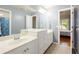 Bathroom featuring double sinks, white cabinetry, and a large mirror at 1059 Verbena Way, Auburn, GA 30011