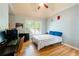 Bedroom with light blue walls, light hardwood floor, and a window at 1059 Verbena Way, Auburn, GA 30011
