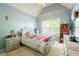 Cozy bedroom with a full-size bed, soft rug, and a bright window, perfect for a or guest at 1059 Verbena Way, Auburn, GA 30011