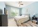 Comfortable bedroom with a queen bed, soft lighting, and a large window overlooking the backyard at 1059 Verbena Way, Auburn, GA 30011