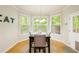 Sun-drenched breakfast nook with hardwood floors, large windows, and a charming table setting at 1059 Verbena Way, Auburn, GA 30011