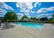 Community pool with lounge chairs and tables surrounded by manicured landscaping at 1059 Verbena Way, Auburn, GA 30011
