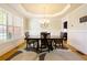 Formal dining room with wainscoting, tray ceiling, and hardwood floors at 1059 Verbena Way, Auburn, GA 30011