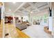 Open concept living room with hardwood floors, coffered ceilings, and a fireplace at 1059 Verbena Way, Auburn, GA 30011