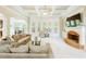 Large living room with a fireplace, a coffered ceiling, and bay windows at 1059 Verbena Way, Auburn, GA 30011
