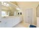 Bright main bathroom with a double sink vanity, large mirror, and access to a walk-in shower at 1059 Verbena Way, Auburn, GA 30011