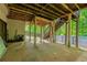 Back patio view with a staircase to the deck, wooden support beams, and a fenced yard at 1059 Verbena Way, Auburn, GA 30011