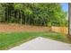 Backyard with a small, fenced in area, a small grass area, and wooded backdrop at 1243 Riverstone Rd, Jonesboro, GA 30238