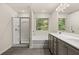 This bathroom is equipped with a double vanity, a glass shower, and a soaking tub at 1243 Riverstone Rd, Jonesboro, GA 30238