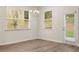 Bright dining room features hardwood floors, and modern windows with access to the backyard at 1243 Riverstone Rd, Jonesboro, GA 30238