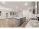 The kitchen features granite countertops, stainless steel appliances, gray cabinets, and an adjoining living area at 1243 Riverstone Rd, Jonesboro, GA 30238