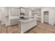 Kitchen features granite countertops, modern appliances, hardwood flooring, gray cabinets, and a kitchen island at 1243 Riverstone Rd, Jonesboro, GA 30238