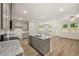 The kitchen offers an island, granite counters, stainless appliances, hardwood flooring, and ample cabinet space at 1243 Riverstone Rd, Jonesboro, GA 30238