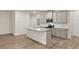 Open kitchen with granite countertops, stainless steel appliances, gray cabinets, and kitchen island at 1243 Riverstone Rd, Jonesboro, GA 30238
