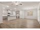 Open-concept kitchen and living area featuring wood floors and neutral decor at 1243 Riverstone Rd, Jonesboro, GA 30238