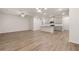 Open-concept living area featuring wood floors, kitchen island, and modern lighting at 1243 Riverstone Rd, Jonesboro, GA 30238
