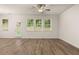 Open living area featuring wood floors, bright windows, and a glass exterior door at 1243 Riverstone Rd, Jonesboro, GA 30238