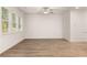 Spacious living area featuring wood floors and bright windows with natural light at 1243 Riverstone Rd, Jonesboro, GA 30238
