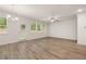 Bright living area with wood floors and a door and windows overlooking the backyard at 1243 Riverstone Rd, Jonesboro, GA 30238
