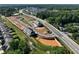 An aerial view showcases the community layout with roads, trees, and townhome clusters at 4527 Moray Dr, Mableton, GA 30126