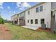 View of a grassy backyard showing the fence and exterior of the townhome at 4527 Moray Dr, Mableton, GA 30126