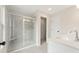Modern bathroom featuring a glass-enclosed shower, white tile, and double vanity at 4527 Moray Dr, Mableton, GA 30126