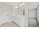 Well-lit bathroom featuring a double vanity, large mirror with lights, and neutral finishes at 4527 Moray Dr, Mableton, GA 30126