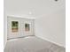 Neutral carpeted bedroom with two bright windows offering a view to the backyard at 4527 Moray Dr, Mableton, GA 30126