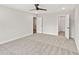 Large carpeted bedroom showing open doorways to a bathroom and closet at 4527 Moray Dr, Mableton, GA 30126