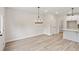 Dining area with modern chandelier lighting and open access to the kitchen at 4527 Moray Dr, Mableton, GA 30126