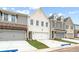 Attractive townhome exteriors with varying textures, attached garages, and well-kept lawns at 4527 Moray Dr, Mableton, GA 30126