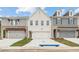 Charming townhome exteriors with brick, siding, and attached garages with well manicured yards at 4527 Moray Dr, Mableton, GA 30126