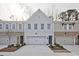 Modern townhome with a brick and siding exterior and an attached garage and concrete driveway at 4527 Moray Dr, Mableton, GA 30126