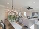 Open-concept living and dining area with hardwood flooring, neutral tones, and modern light fixtures at 4527 Moray Dr, Mableton, GA 30126