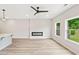 Open-concept living space with a sleek fireplace and bright windows at 4527 Moray Dr, Mableton, GA 30126