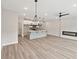 Open-concept living space includes a kitchen, dining room and electric fireplace at 4527 Moray Dr, Mableton, GA 30126