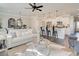 Open-concept living space with a kitchen island, hardwood flooring, modern decor, and plenty of natural light at 4527 Moray Dr, Mableton, GA 30126