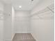Carpeted walk-in closet with built-in shelving and ample storage space at 4527 Moray Dr, Mableton, GA 30126